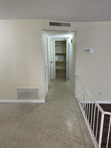 Hallway with linen closet at end - 6300 Mosby Pl