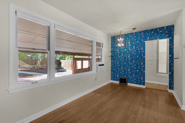 Corner of living room with wallpaper highlight and view into private back yard. - 114 N Foote Ave