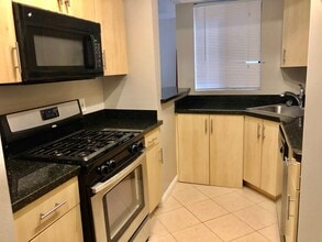 Building Photo - REMODELED CONDO WITH WOOD FLOORS! NEW KITCHEN! FIREPLACE! GYM, POOL! REC ROOM AND MORE