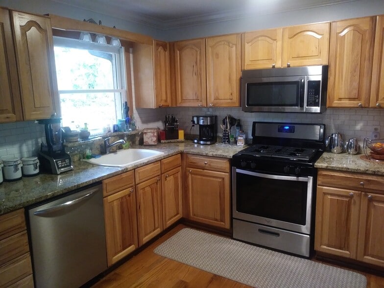 Brand new stainless-steel appliances and hardwood cabinets Granite counter-top and sleek tile backsplash - 701 Rosalyn Dr