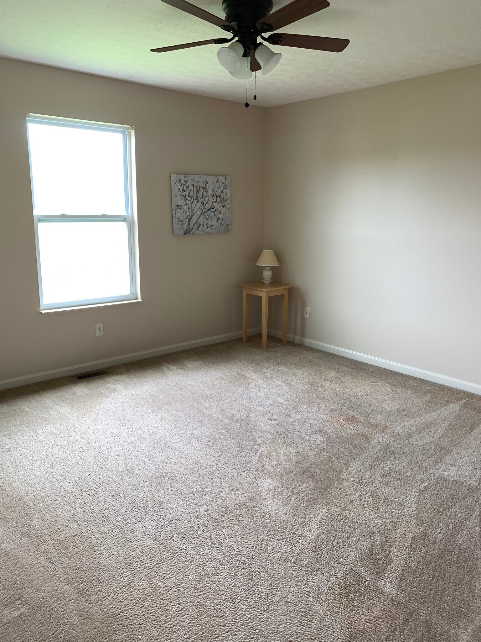 Neutral master bedroom with ceiling fan - 6869 Gordon Blvd