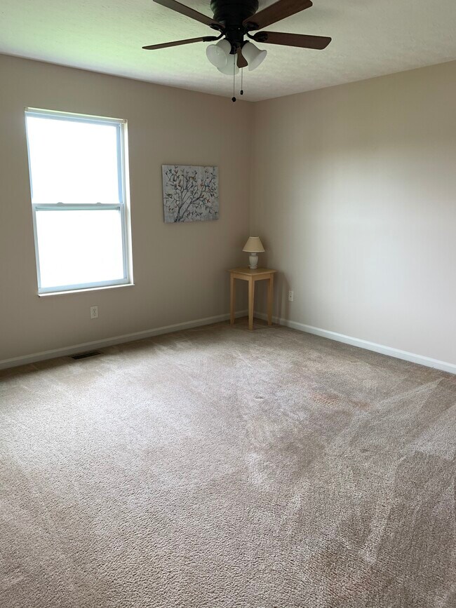 Neutral master bedroom with ceiling fan - 6869 Gordon Blvd