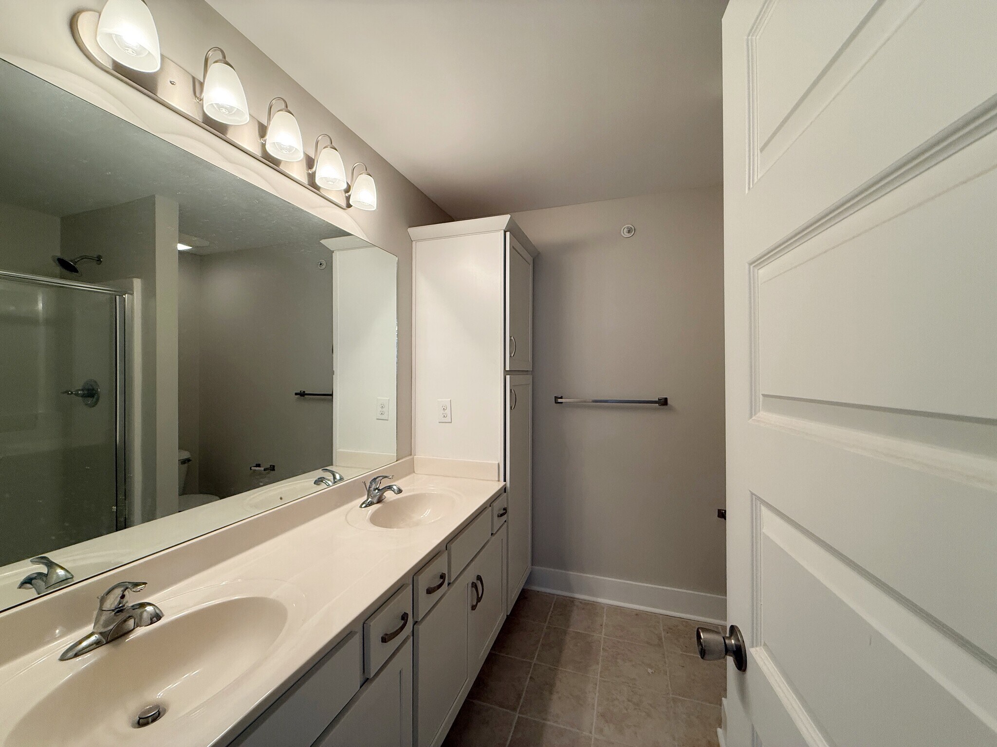 Primary bath with two sinks and walk-in shower - 3010 Bellflower Cir