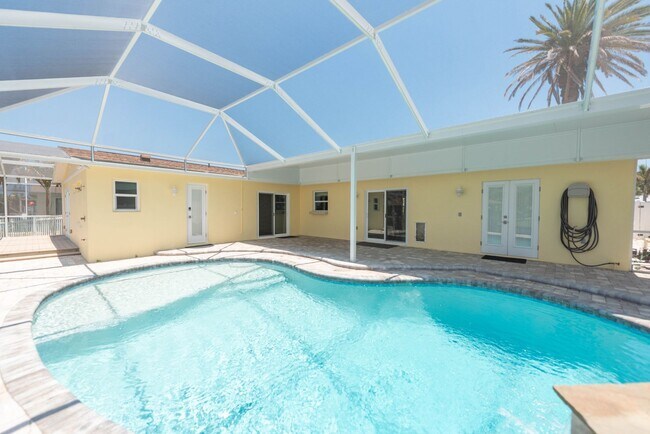 Building Photo - Live the ultimate Space Coast waterfront lifestyle at this stunning beachside canal home in Satel...