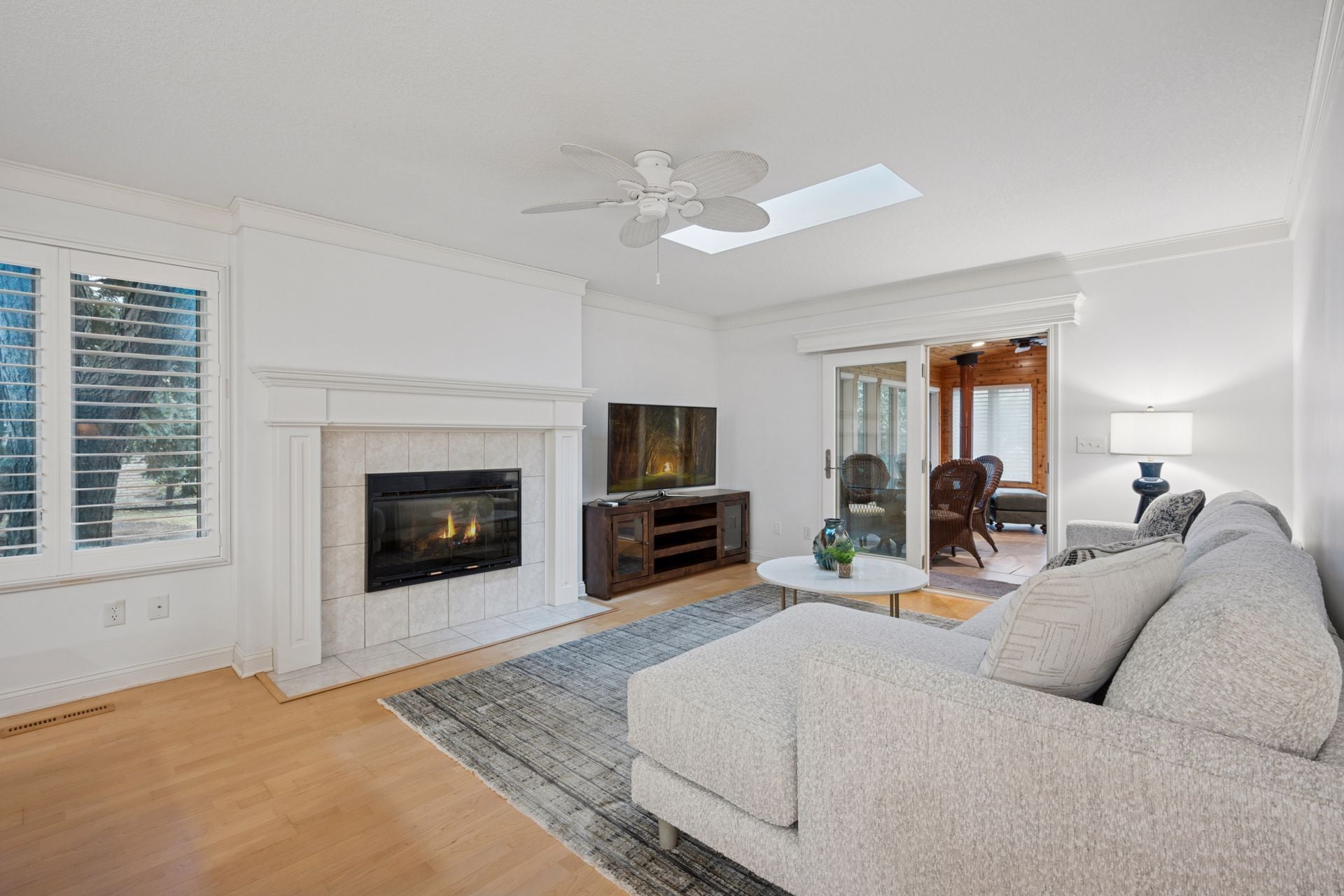 Living area with cozy gas fireplace and skylight - 145 Holly Ln N