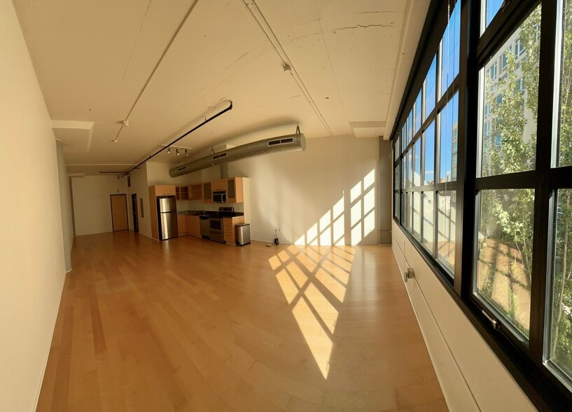 Full Loft, facing kitchen area and front door from exterior window -- no furnishing - 1400 NW Irving St