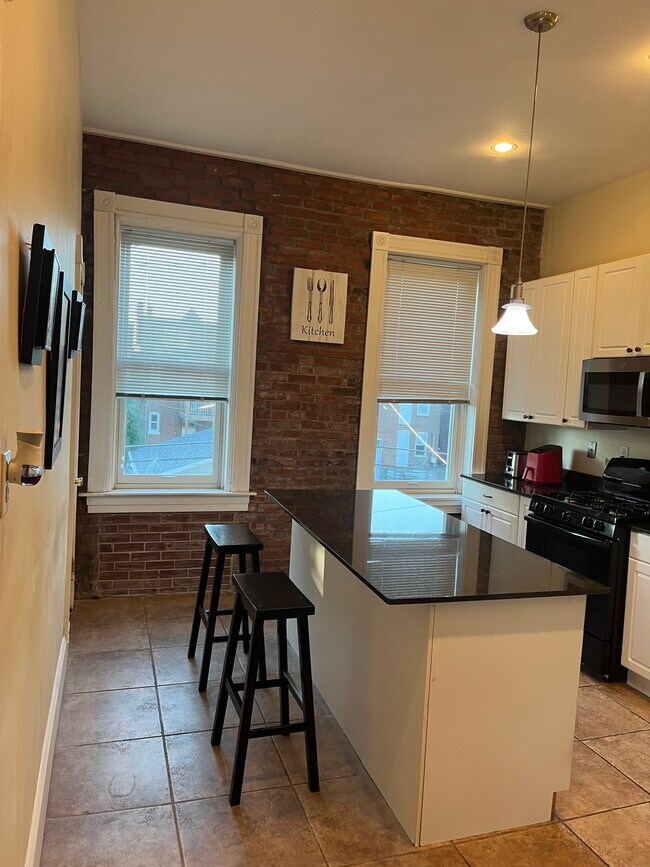 Kitchen with full stove; microwave, dishwasher, air fryer, and Keurig - 2219 Missouri Ave