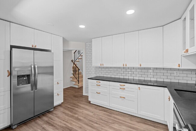 Building Photo - Completely Renovated Corner Townhome with Modern Kitchen, Designer Baths, and Private Yard