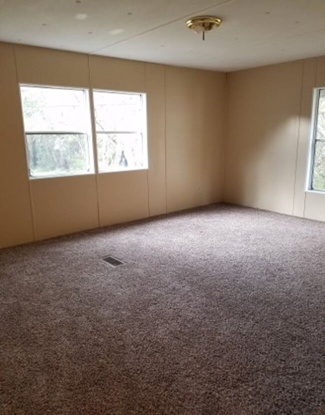 Building Photo - Freshly painted spacious 2-bedroom 1-bath home with a screened porch and storage shed.
