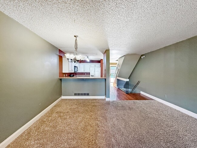 Building Photo - $0 DEPOSIT OPTION. CHARMING TWO-STORY TOWNHOUSE WITH FINISHED BASEMENT, GARAGE, AND HOA AMENITIES...