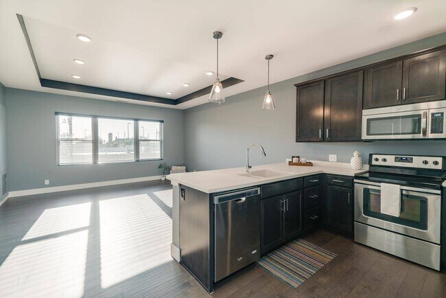 Open-concept layouts connect the kitchen and living areas, providing a seamless space to relax or gather. - The Helen