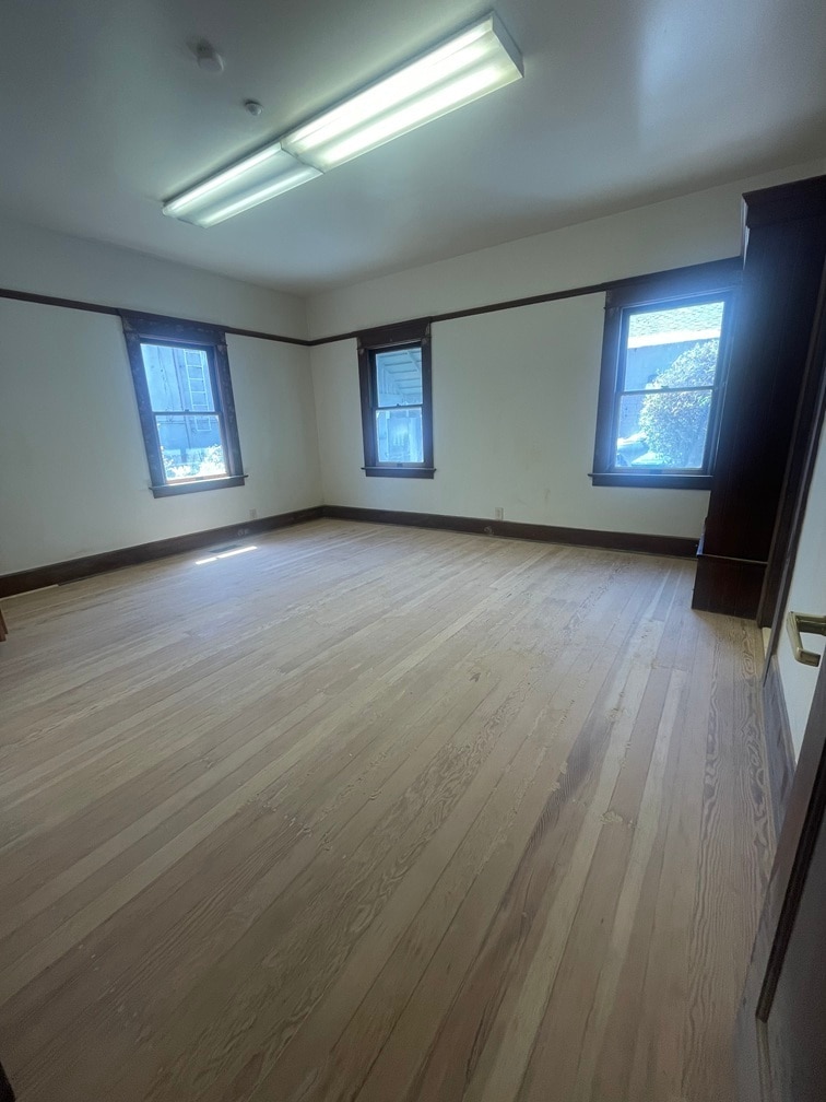 Third large bedroom with hardwood floors adjacent to a large, completely renovated full bathroom. - 1135 Magnolia St