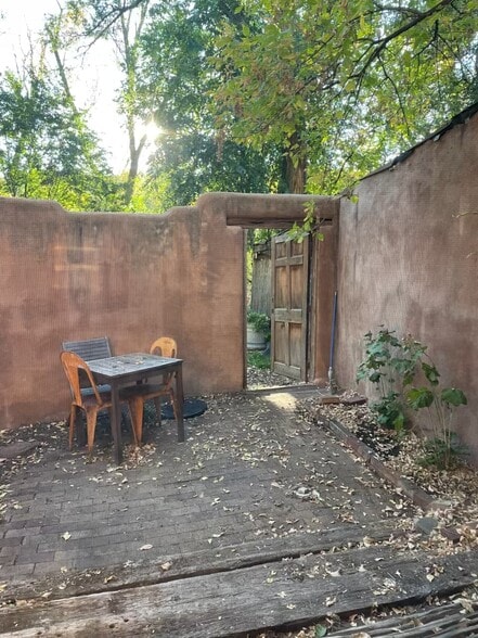 Enclosed private patio with door leading to grassy back yard - 1470B Bishops Lodge Rd