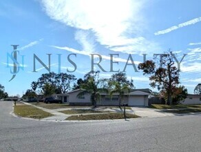 Building Photo - This 3/2/1 with over 1100 sq ft offers all tile floors open kitchen/dining, split floor plan on a...
