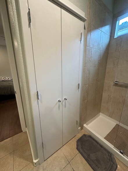 Cabinet in bathroom holding washer/dryer with door closed - 2534 Napier Ct