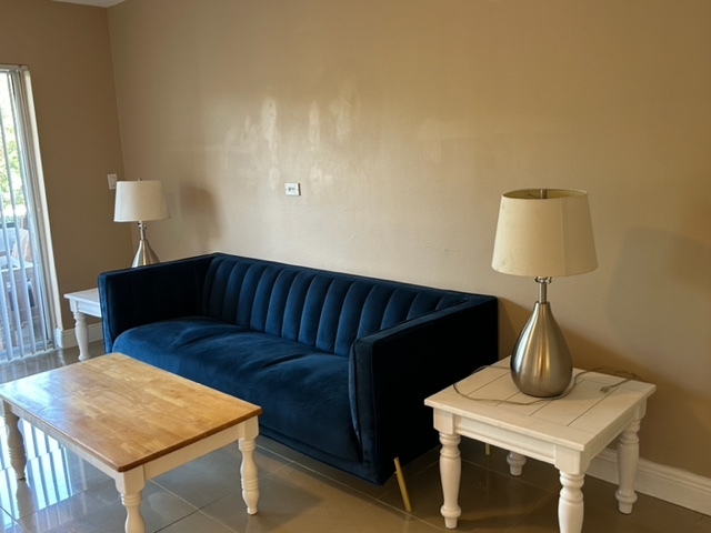 Living room with couch and tables - 490 NW 20th St