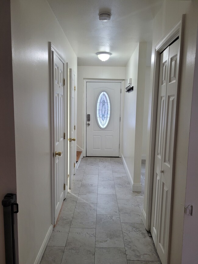 Living Room wholeway with finished basement door. - 12 Strawberry Hill Rd