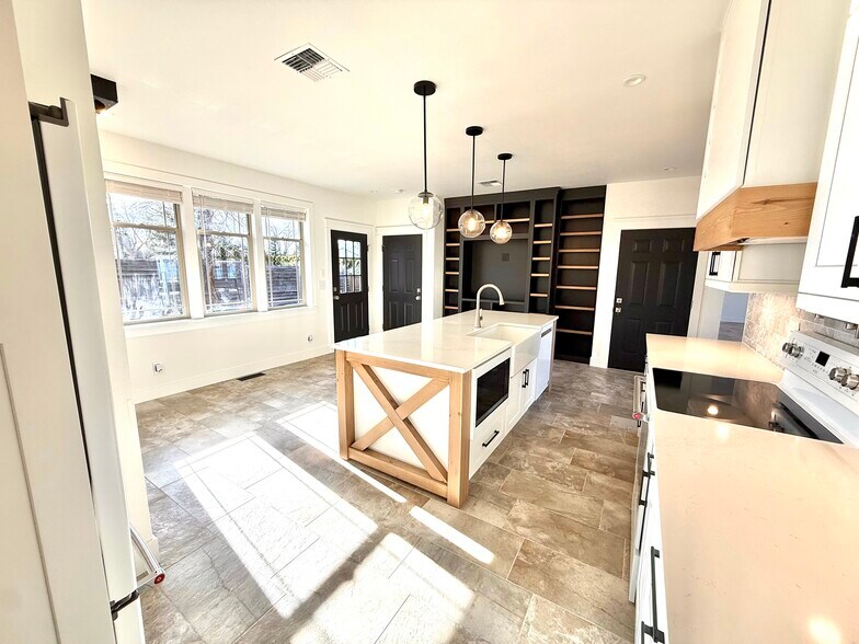 Kitchen. 3 doors lead to backyard, loft and basement - 24 Ash St N