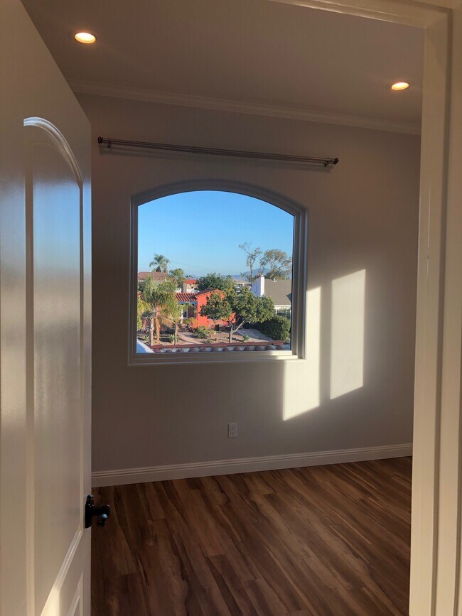 Bedroom door and picture window facing east for beautiful sunrises. - 4470 Swift Ave