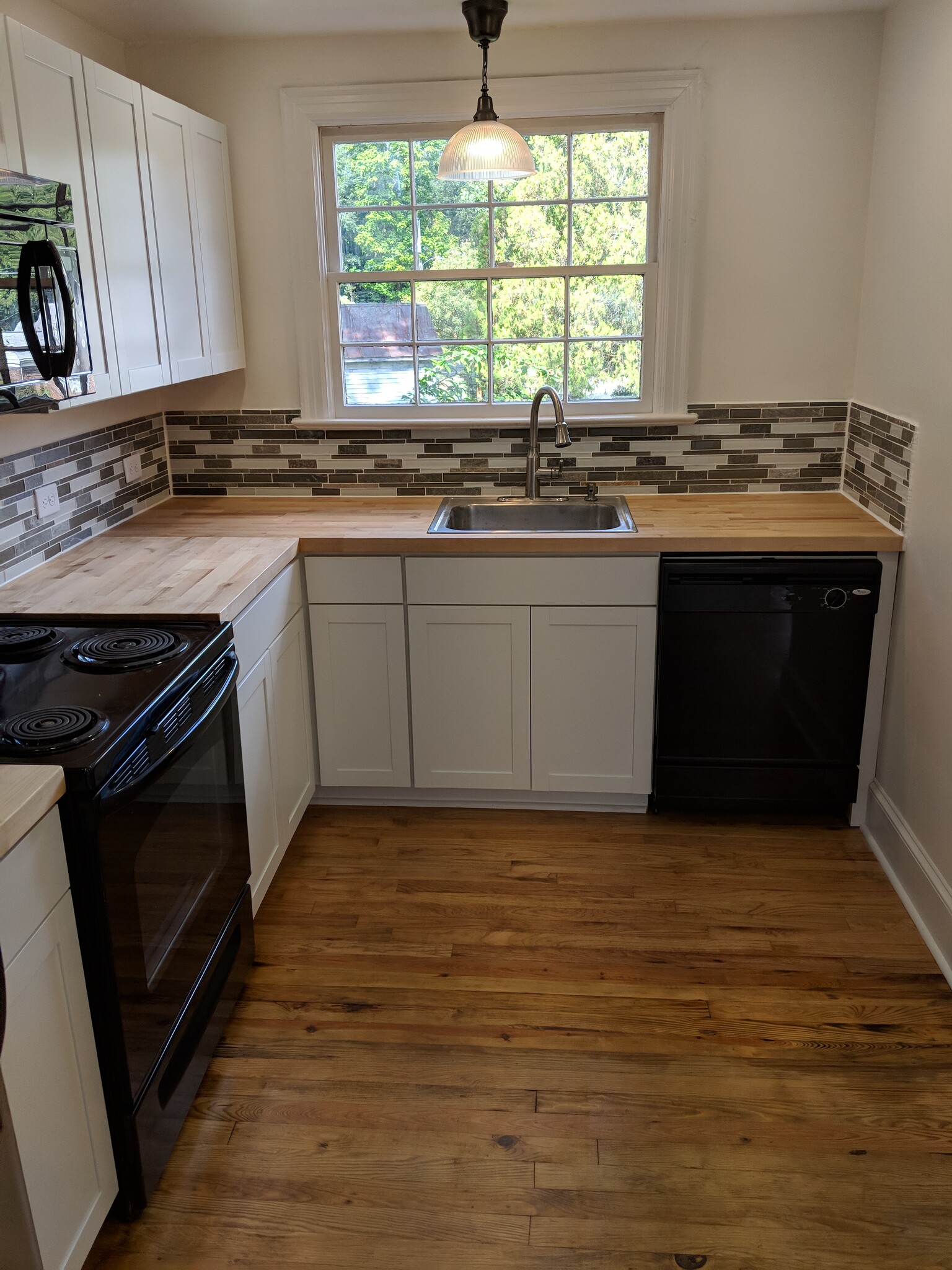 Very well lit and brand new cabinets, counters and backsplash! Beautiful kitchen! - 1111 Watauga St