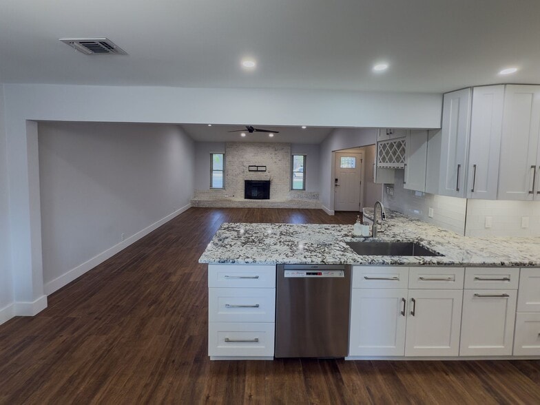 Wide-angle living room with stone fireplace and open floor plan - 2006 Candle Ct