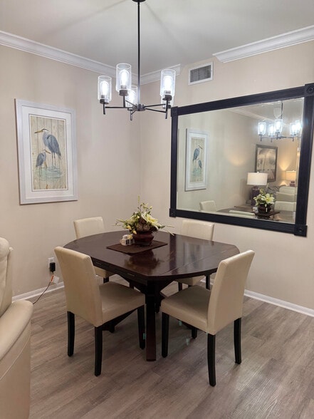Dining area with dimmer lighting above. - 9231 Spring Run Blvd