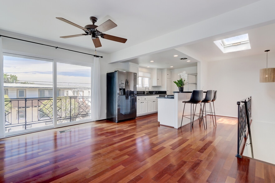 Spacious great room with open kitchen and balcony. - 744 12th St