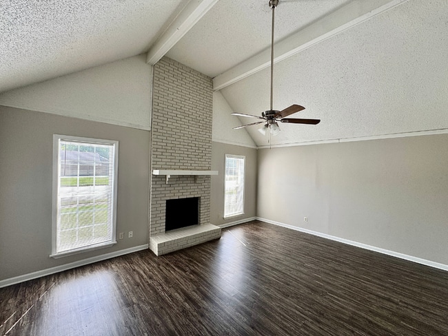 Building Photo - Charming 3BR/2BA Near Southwind | Soaring Vaulted Ceilings, Brick Fireplace & Fenced Yard