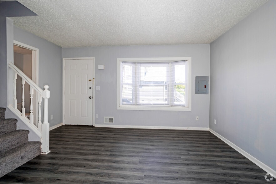 3BR, 1.5BA - 1,129SF - Living Room - Charles Drew Court Apartments