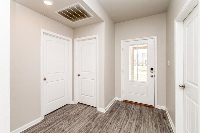 Hallway to laundry, 3td bedroom, and front door - 48465 Red Fox Dr