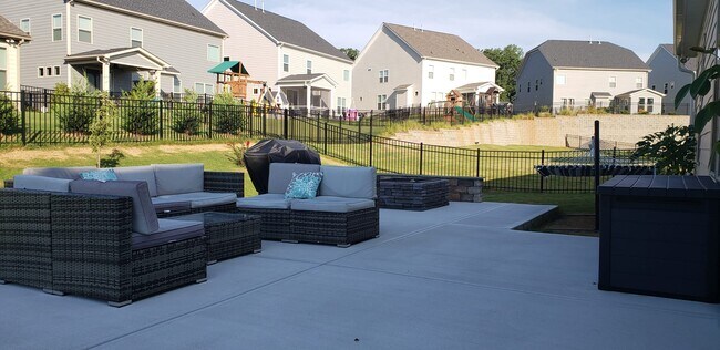 large patio with built-in fire pit and stone bench - 4511 Waylon Ave