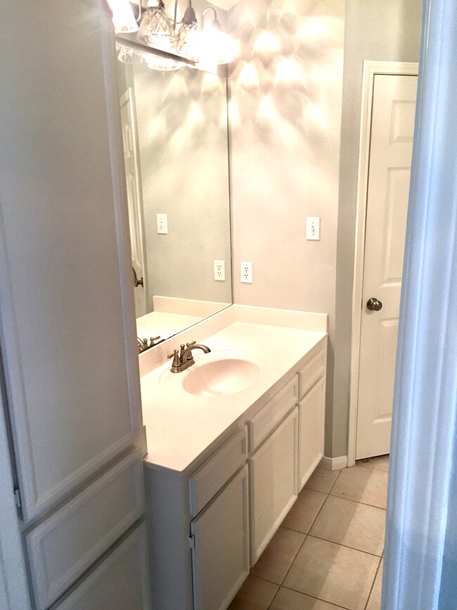 Master bathroom with two separate vanity areas as well as two walk-in closets. - 7921 Pecan Dr