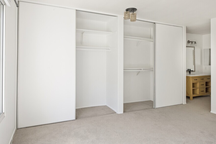 Primary Suite #1- spacious sliding closets with built in shelving - 8740 Tuscany Ave