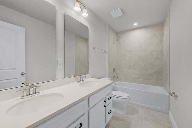 Building Photo - Brand-New 4BR Home with Tile Floors & Quar...