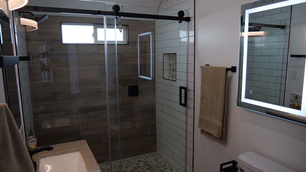 Totally renovated to modern standards. Roomy shower with lighted wall mirror. - 259 E Puente St
