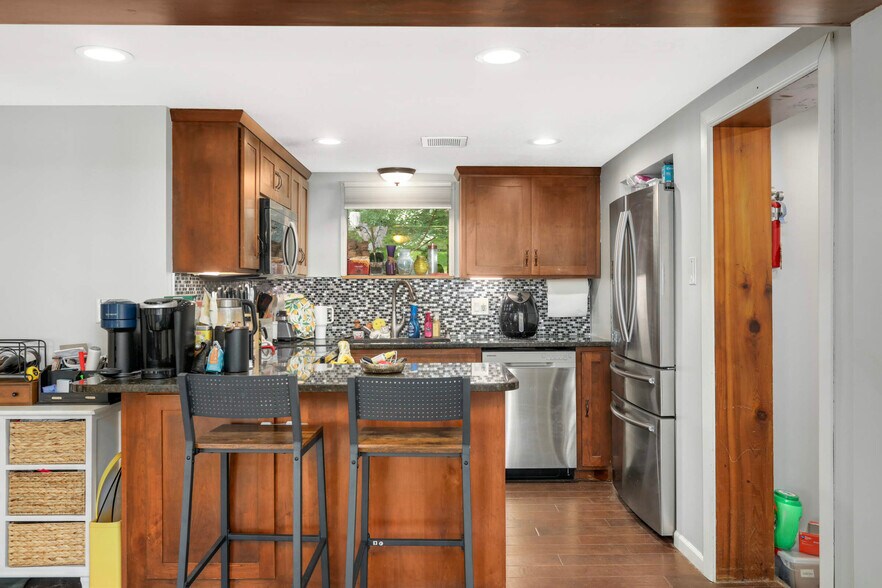Kitchen has a microwave, large fridge freezer, stove and microwave - 14710 13th Ave N
