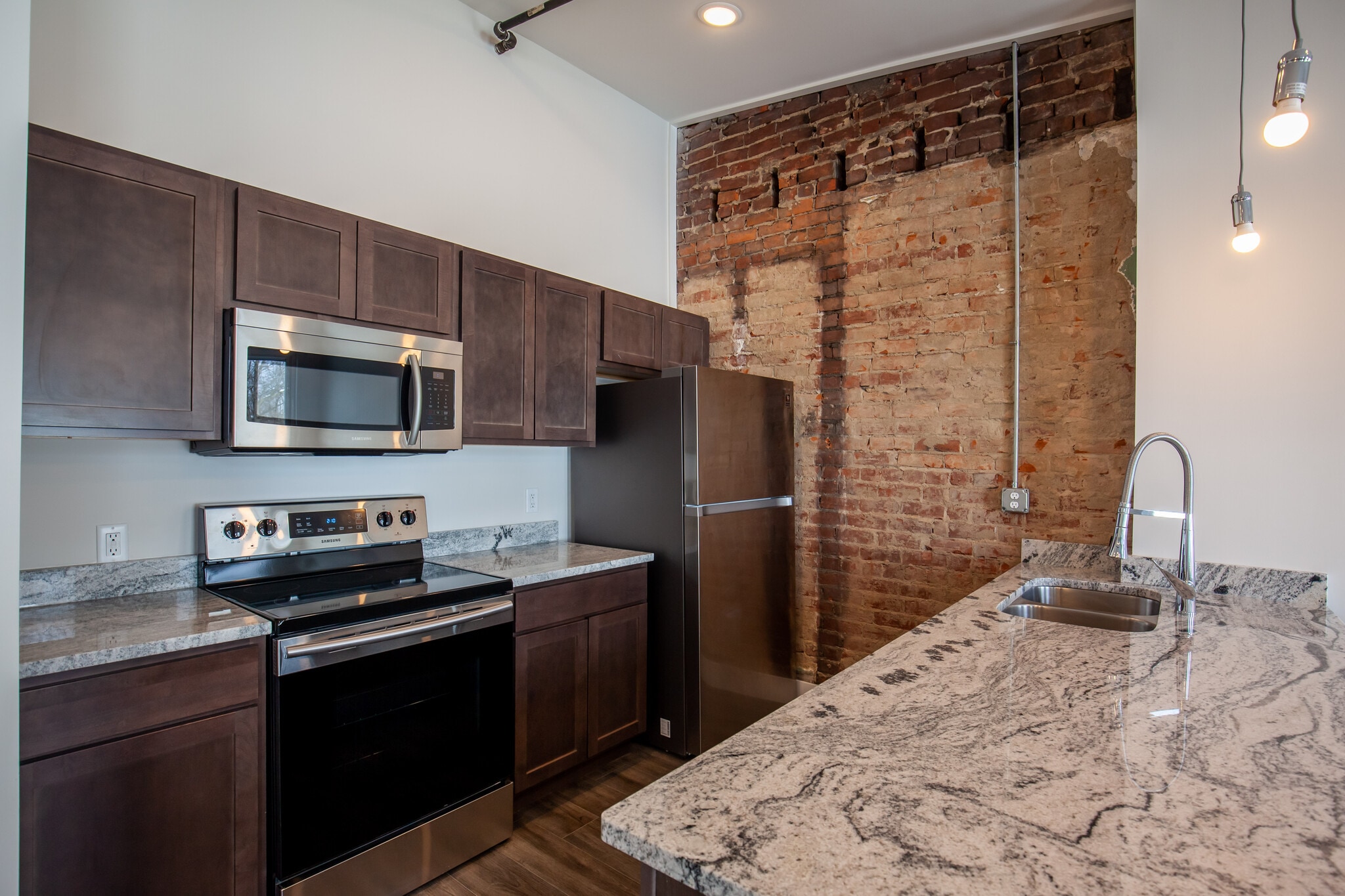 High end finishes includes granite counters, solid wood cabinetry, nice stainless appliances. - 722 E McMillan St