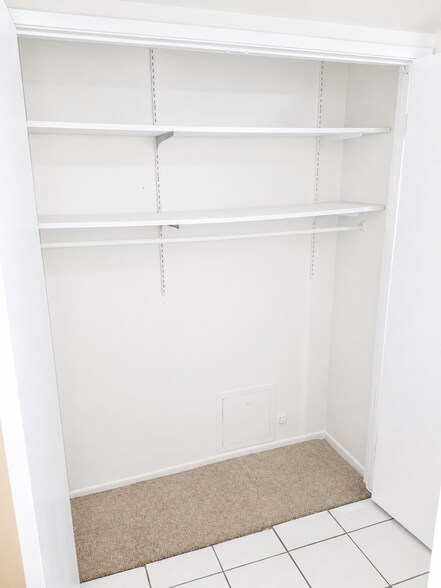 Extra interior storage space with shelving and hanging rod. - 339 E Taft Ave