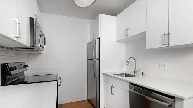 Kitchen with Stainless Steel Appliances and Quartz Countertops - Arbor Terrace