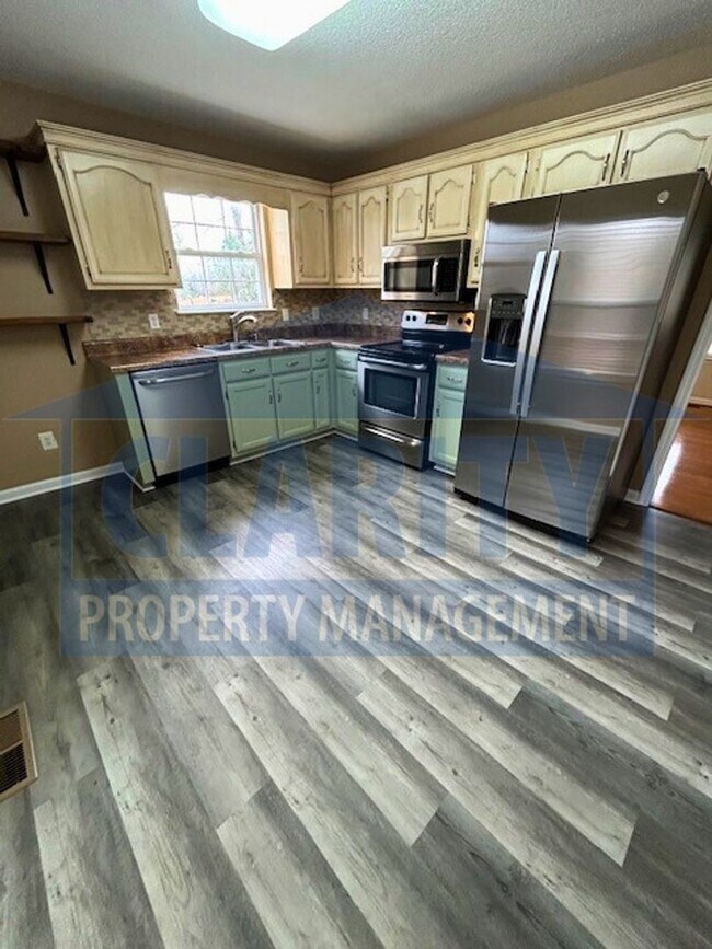 Building Photo - Three bedroom with attached garage!