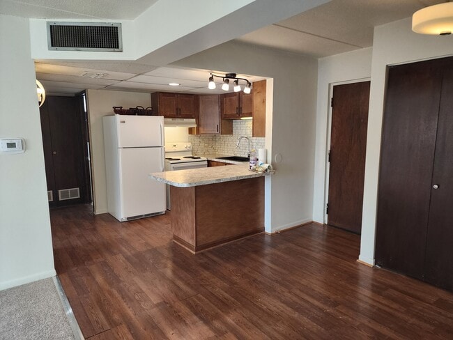 Kitchen with bar stool seating - Sheridan Center Apartments