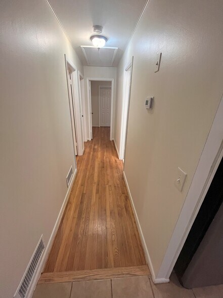 Hallway with access to bedroom #1 & #2 on the left side and bathroom door on right. 2 - 1405 Southland Vista Ct NE