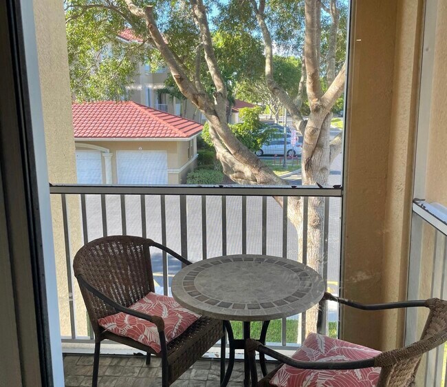 Screened lanai overlooking the community pool. - 1504 SW 50th St
