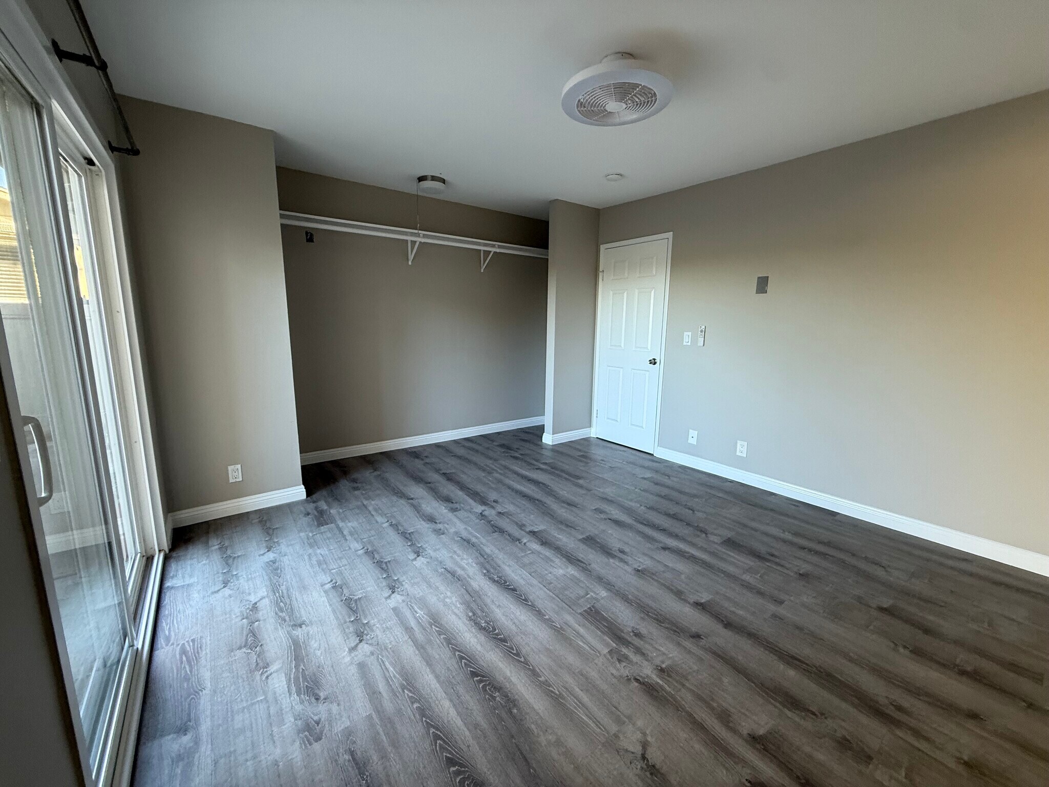 Master bedroom with sliding glass door to the patio and large closet - 1954 Misty Cir