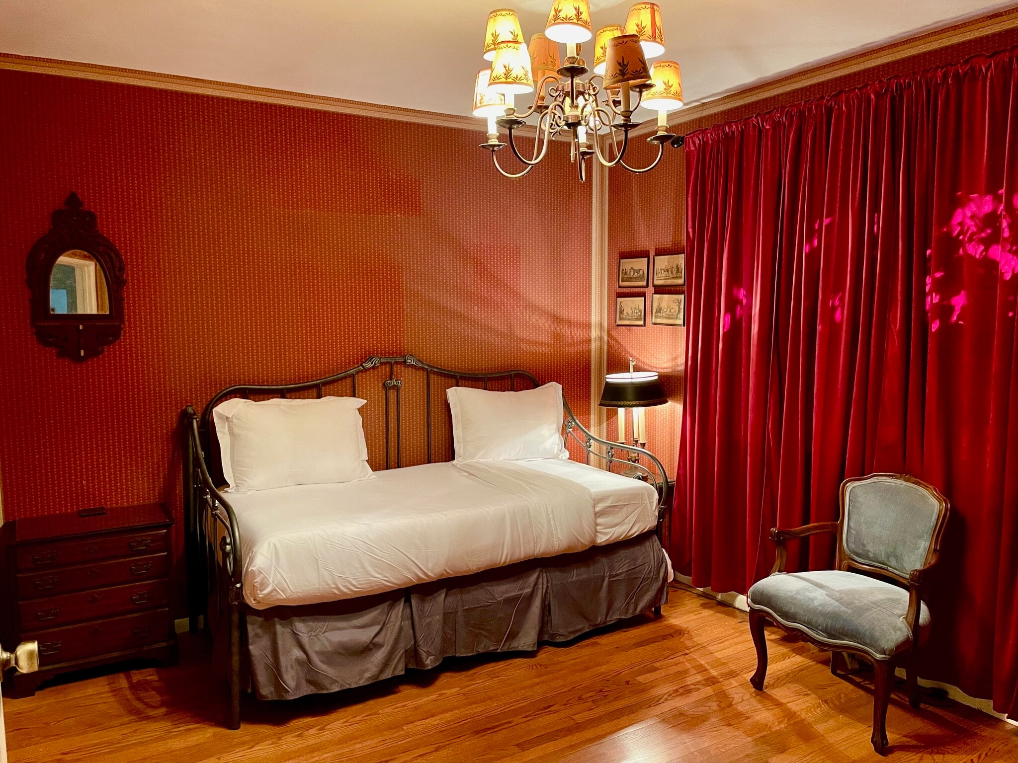 The middle bedroom has antique furnishings and wallpaper that accent the midcentury home. - 11449 Woodbine St