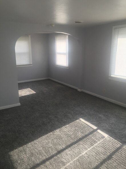 Carpet throughout creates a cozy environment in the living area and bedroom. - 3364 Church St