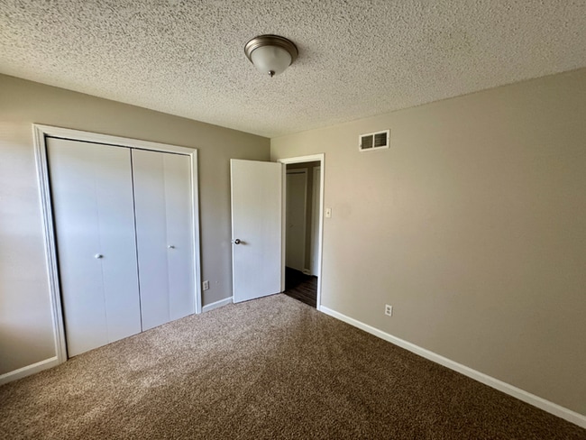 Building Photo - Charming 3BR/2BA Near Southwind | Soaring Vaulted Ceilings, Brick Fireplace & Fenced Yard