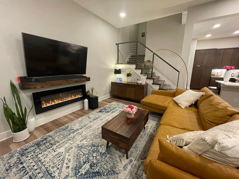 The living room has a built in mantle and ambient electric fireplace. - 216 E Center St