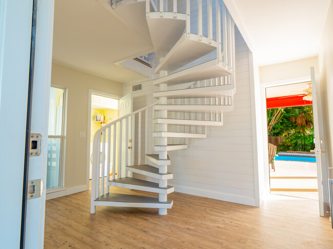 Foyer with grand, sweeping stairs up to the main living level. - 3250 E De Bazan Ave