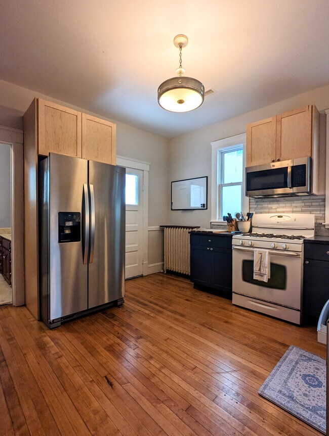 Kitchen with hardwood floors, stainless appliances, maples cabinets, granite counters - 7216 W Clinton Ave